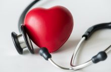 Red heart with a stethoscope draped around it, symbolizing heart health and medical care